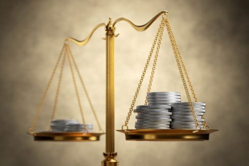 Stock photo, balance scale with coins on each tray